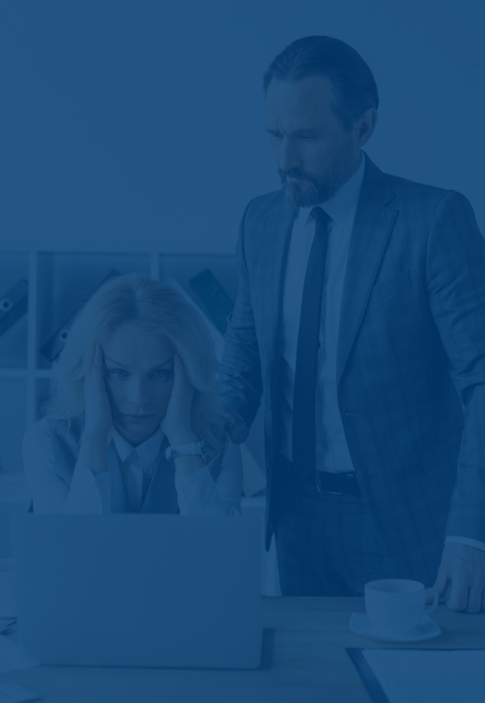 Man and woman looking at laptop concerned about business vulnerability to risk.